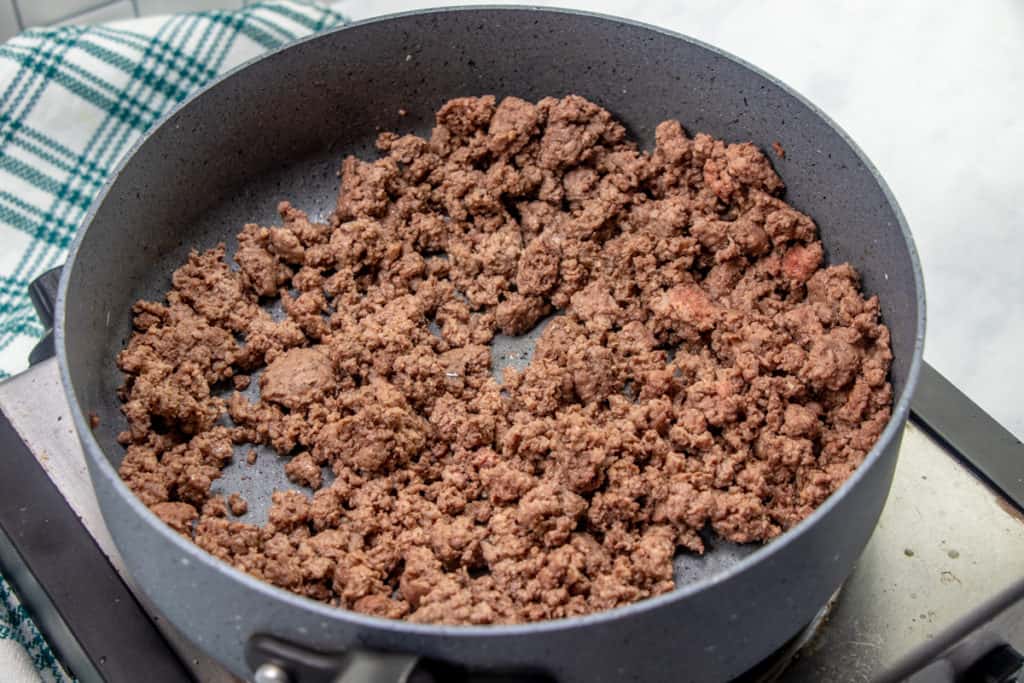 browned and crumbled ground beef in a large skillet