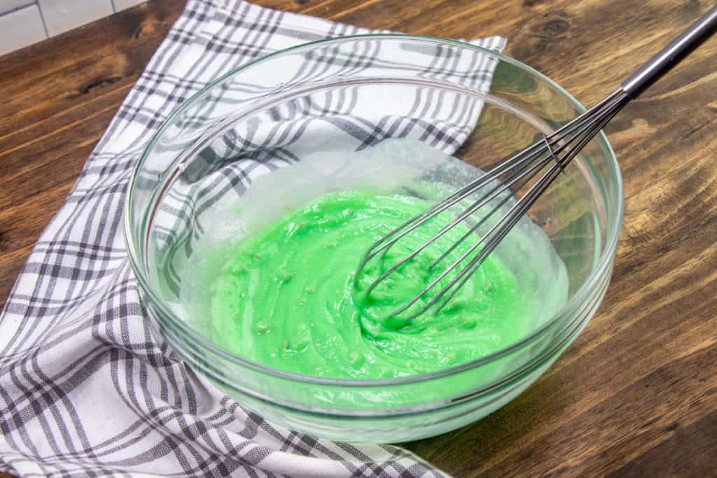 instant pistachio pudding whisked together with milk in a glass bowl
