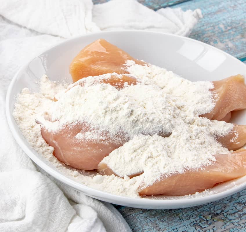 coating sliced chicken breasts in flour