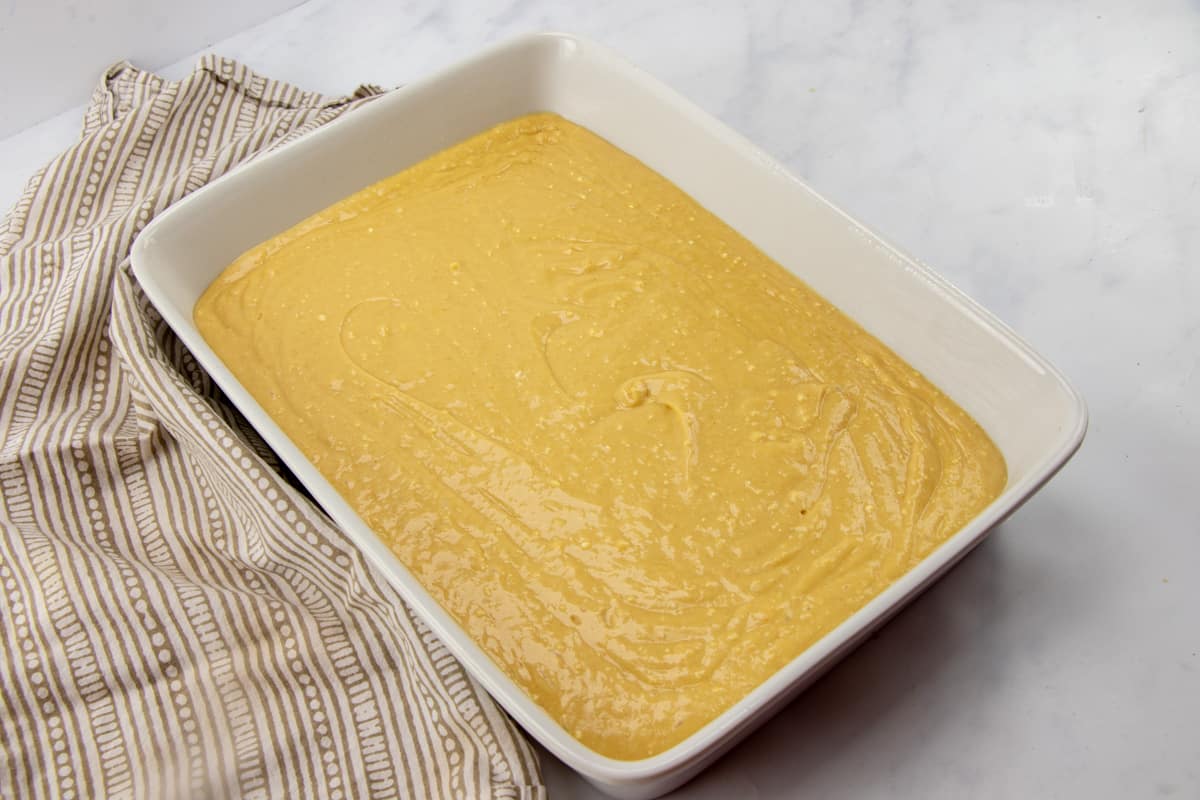 peanut butter cake batter in a greased baking dish.