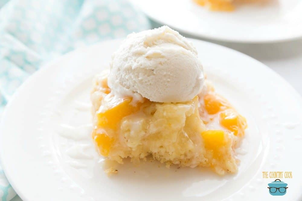 Peach Cobbler Cake slice with scoop vanilla ice cream