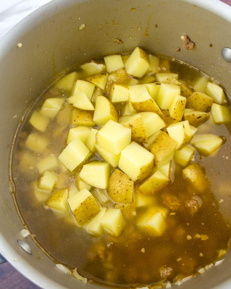 diced potatoes and chicken broth added to large stock pot.