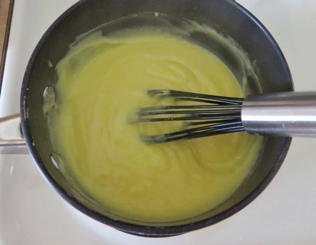 thickened filling with a whisk in a black sauce pan