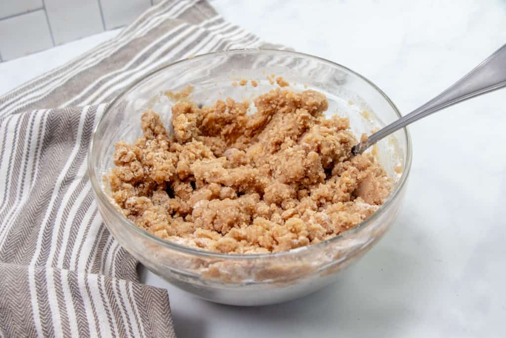 melted butter combined with flour, cinnamon and brown sugar mixed with a fork in a bowl.