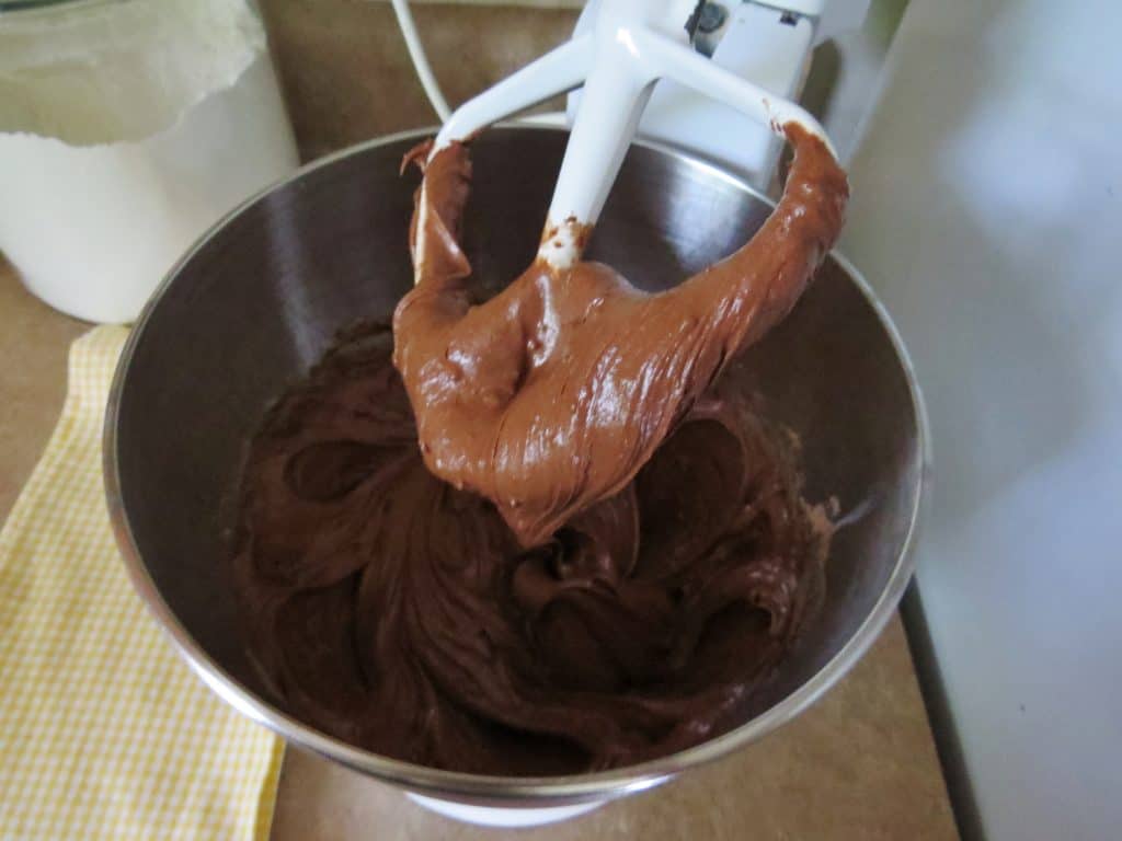cake mix batter in the bottom of an electric mixer