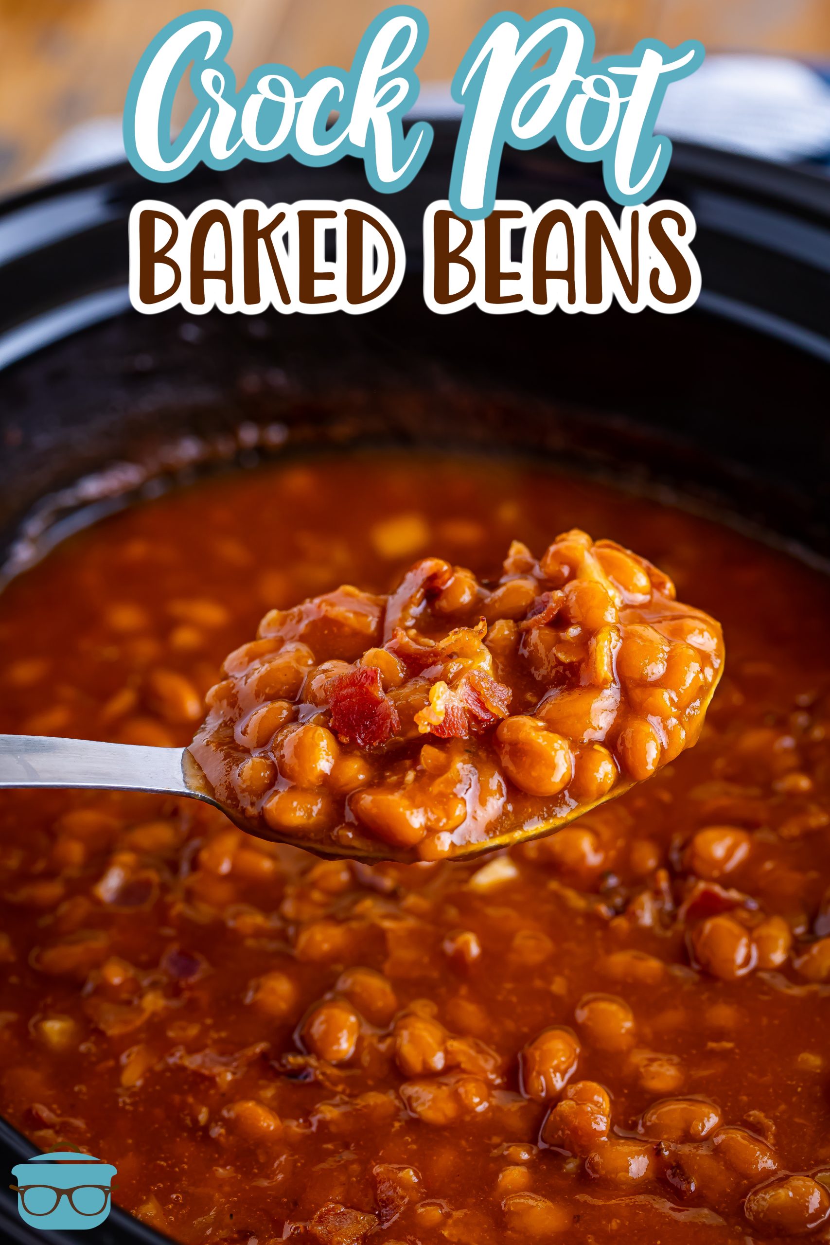 A spoon holding a scoop of Crock Pot Baked Beans over the rest of them.