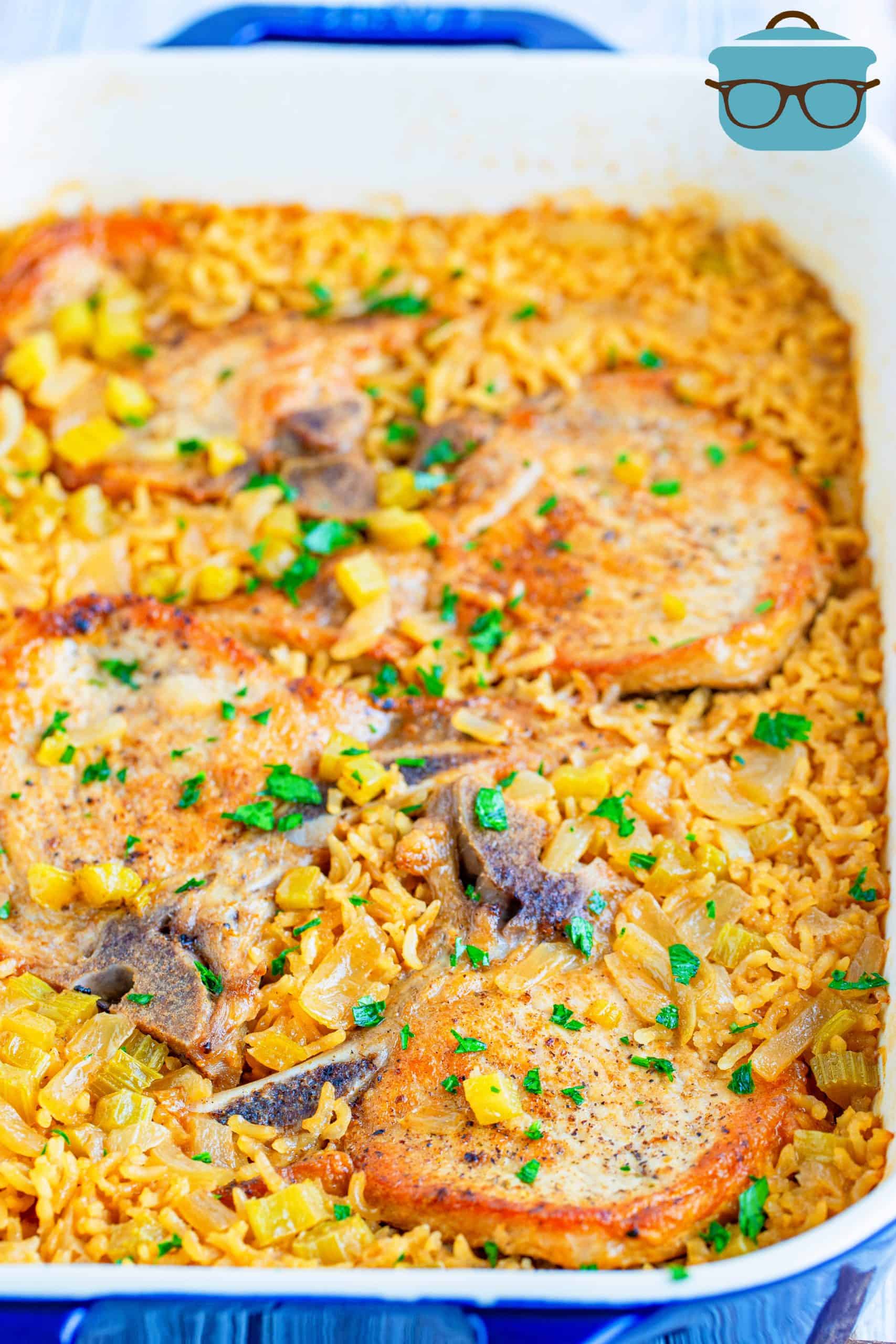 rice and pork chops shown fully baked in a baking dish.