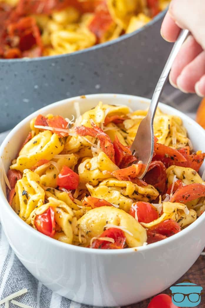 Easy Italian Cheese Tortellini Skillet Meal served in a bowl with a fork being inserted.