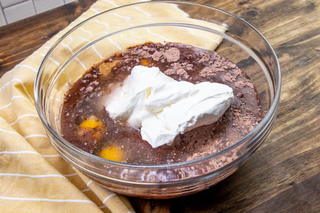 eggs, sour cream, cake mix, chocolate pudding, oil and water in a large glass mixing bowl
