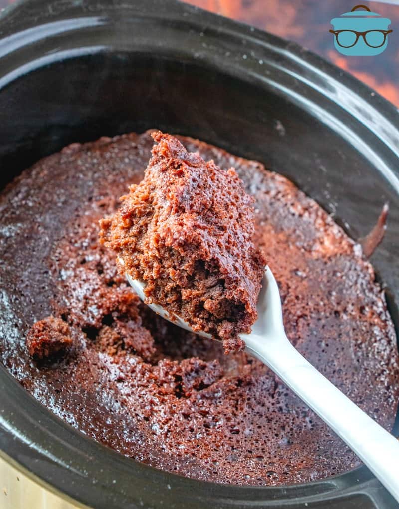 finished, Crock Pot Chocolate Spoon Cake with a white spoon scooping up some of the cake