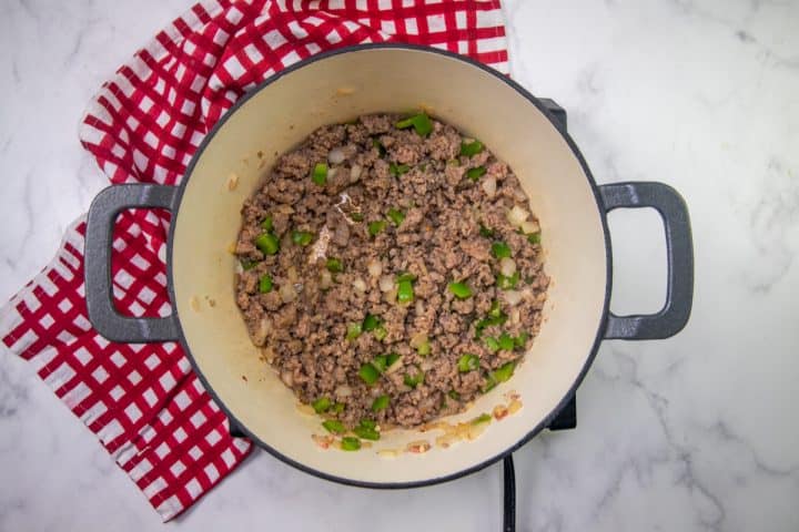 browned ground beef, onion and green pepper in a dutch oven.