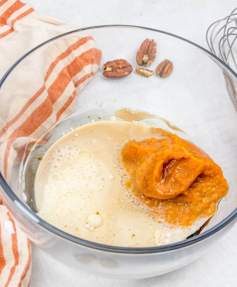 pumpkin, oil, vanilla extract and milk combined in a bowl