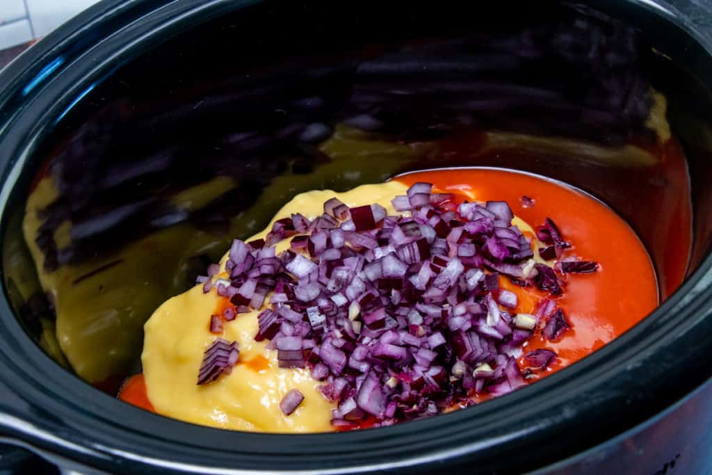 hot sauce, cream of chicken, diced onion in the bottom of a round slow cooker