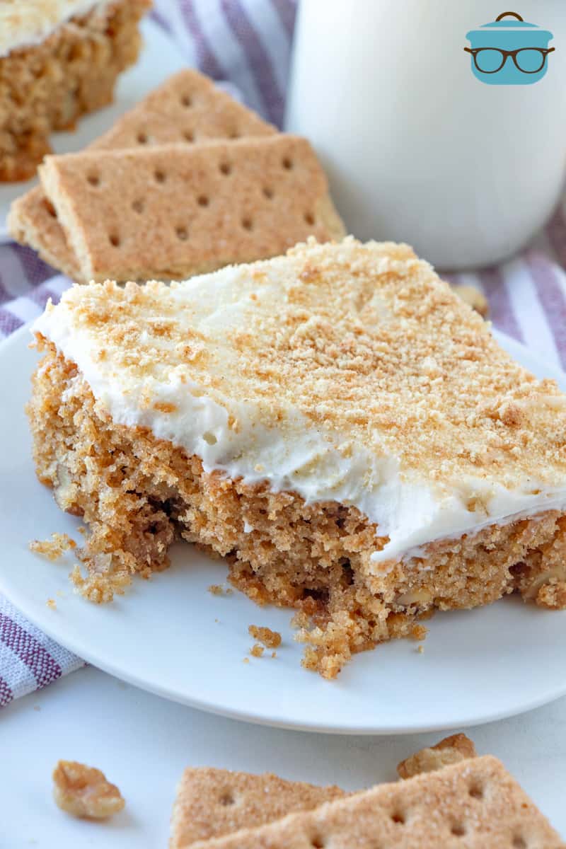 a slice of graham cracker cake with a bite removed. 