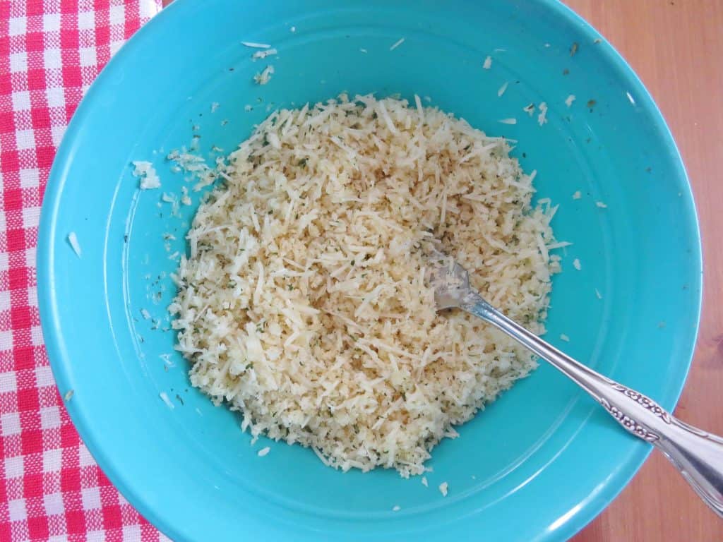 Panko bread crumbs, Parmesan Cheese, melted butter and parsley mixed together in a bowl