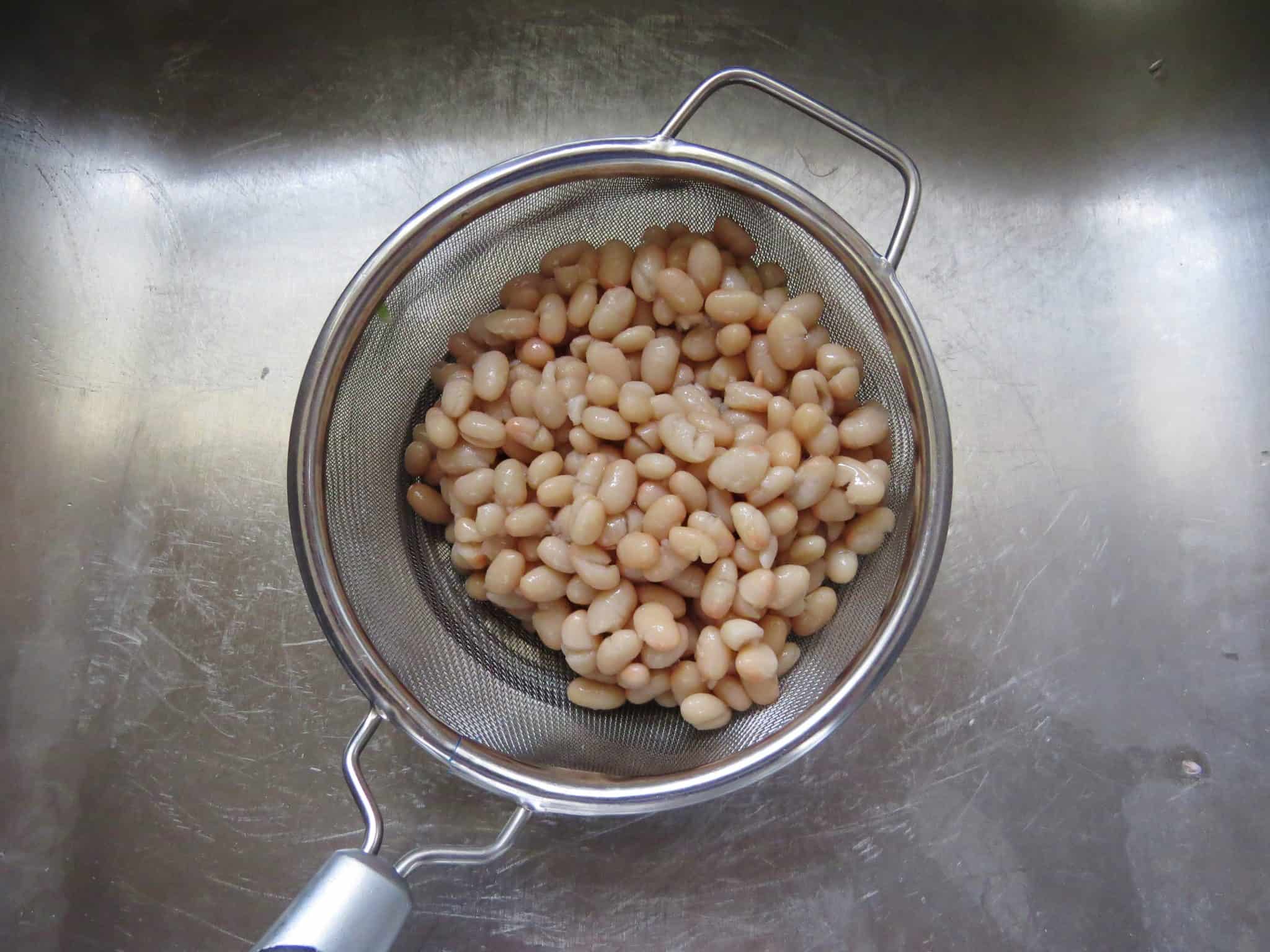 draining beans in a strainer. 