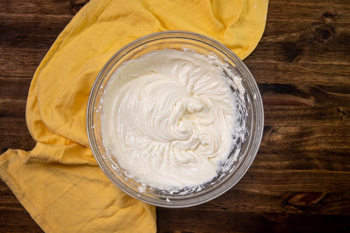cream cheese, sour cream and sugar mixed together until creamy in a large clear bowl.