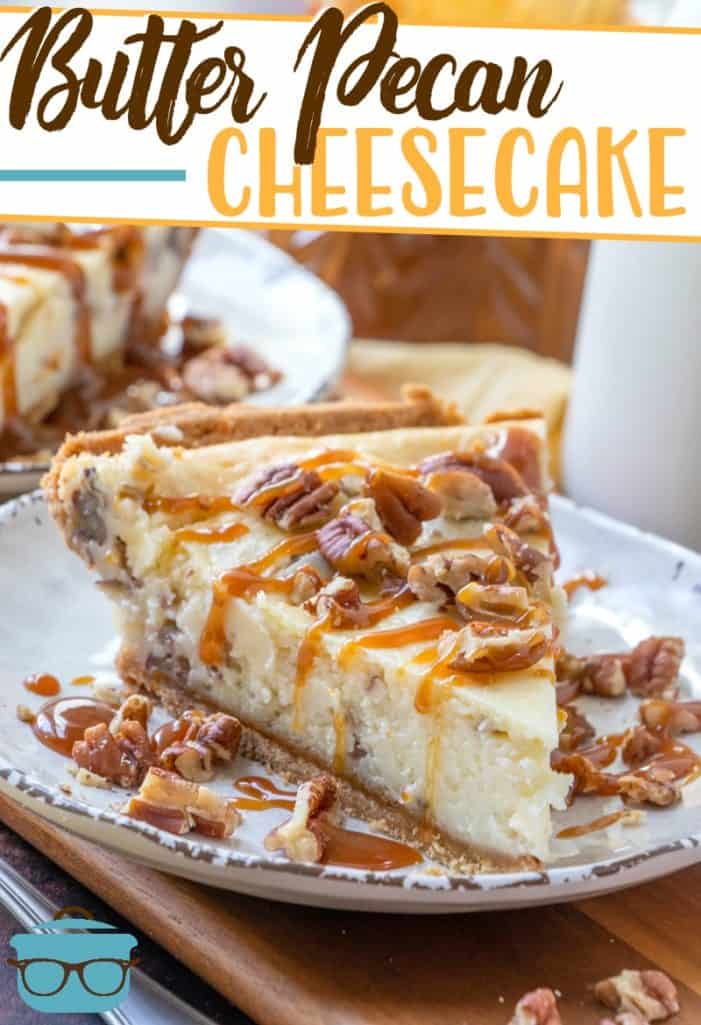 The Best Easy Butter Pecan Cheesecake recipe from The Country Cook, slice, served on a plate, drizzled with caramel and topped with chopped pecans