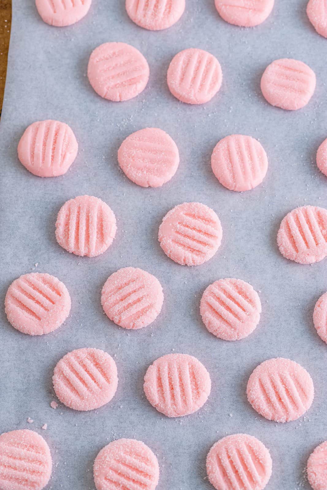 cream cheese mints fully made on parchment paper on a baking sheet.