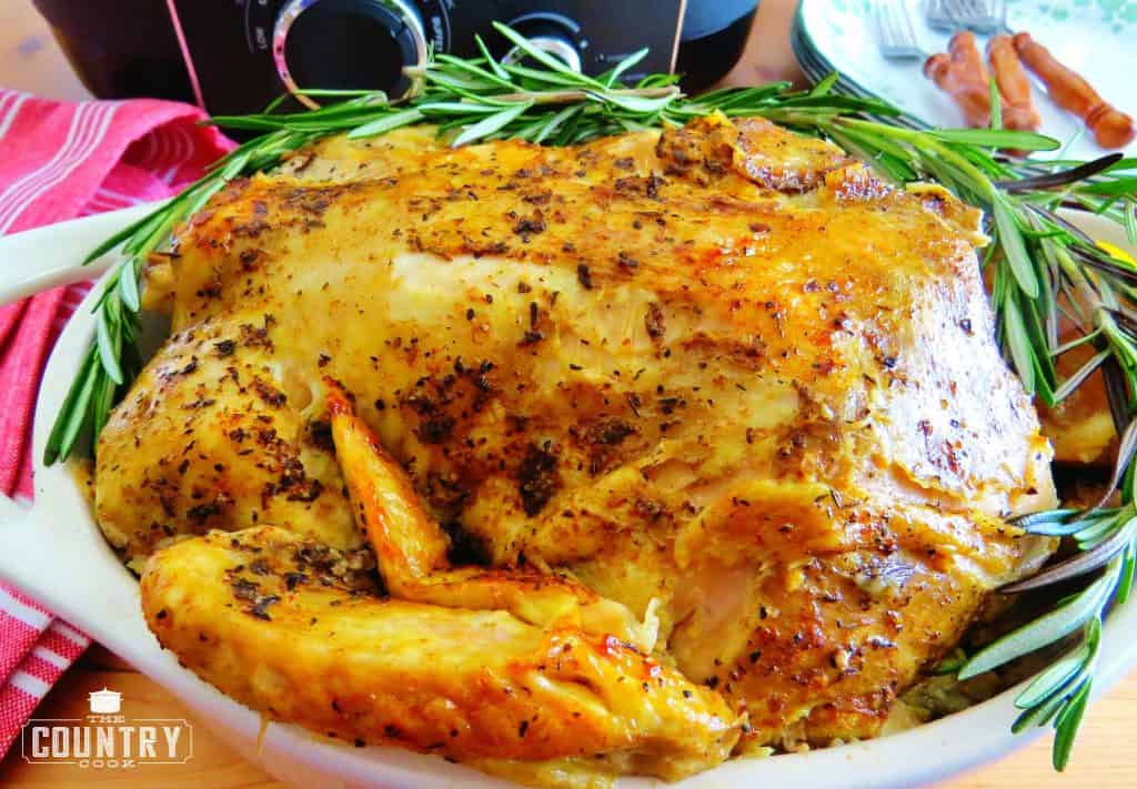 seasoned, cooked chicken in a dish with sprigs of rosemary
