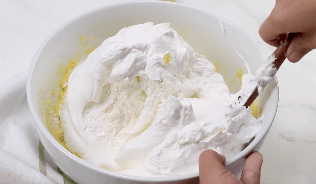 cool whip mixed with instant pudding in a large bowl
