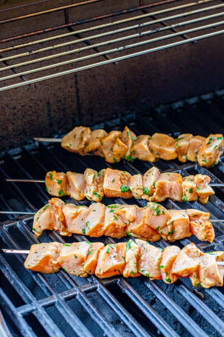 marinated chicken skewers on grill.