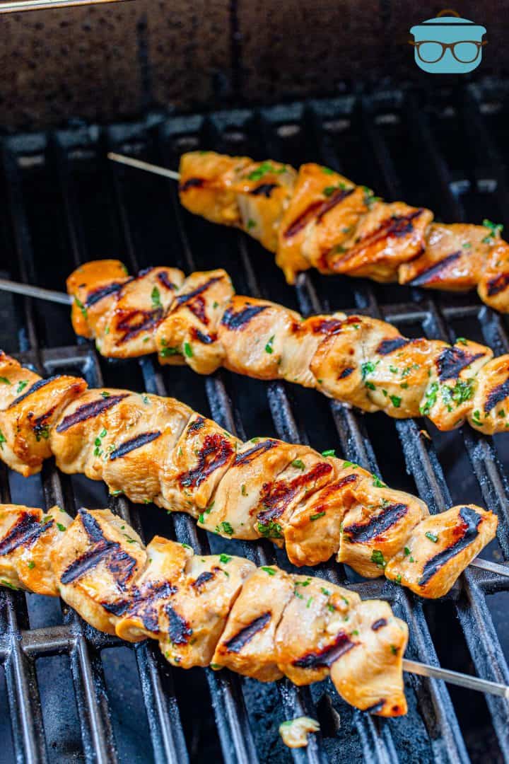 fully cooked and grilled chicken skewers on the grill.