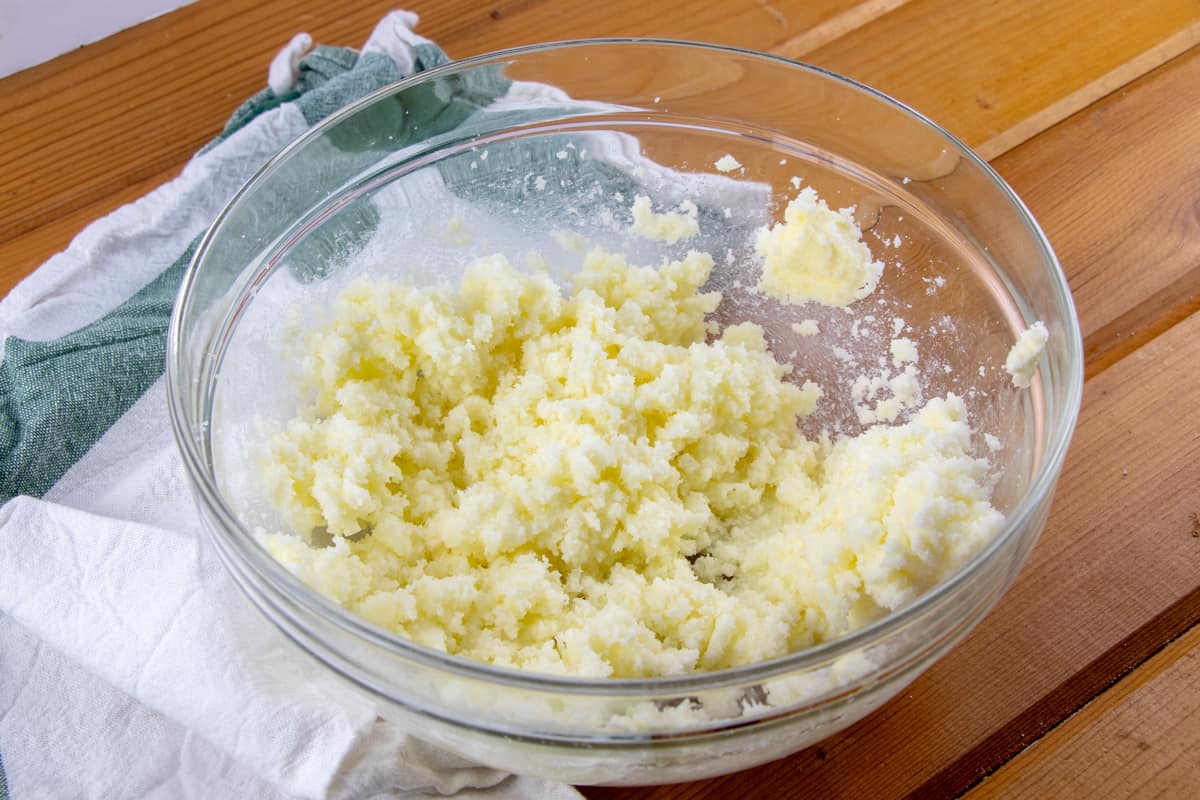 butter and sugar mixed together until fluffy in a clear bowl.