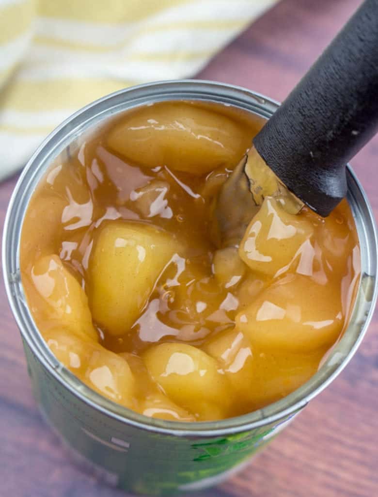 canned apple pie filling with a knife shown inside.