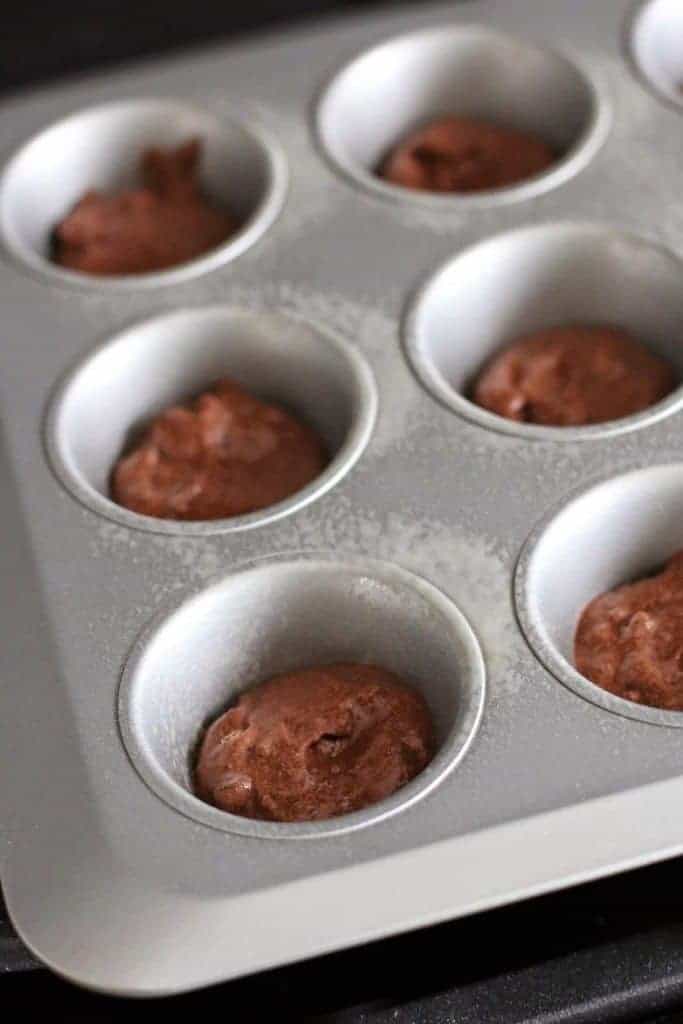 chocolate muffin batter in muffin tin.