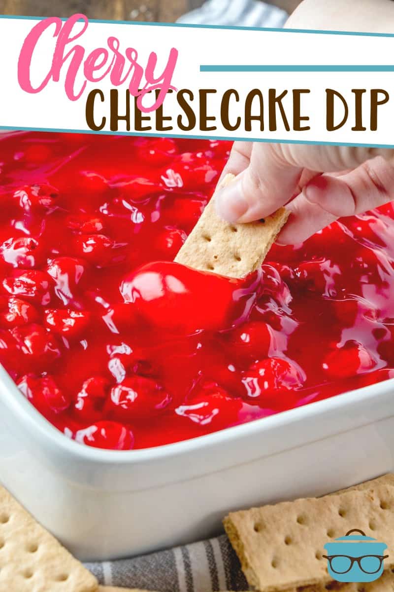 Caucasian female hand dipping a graham cracker into the cherry cheesecake dip.