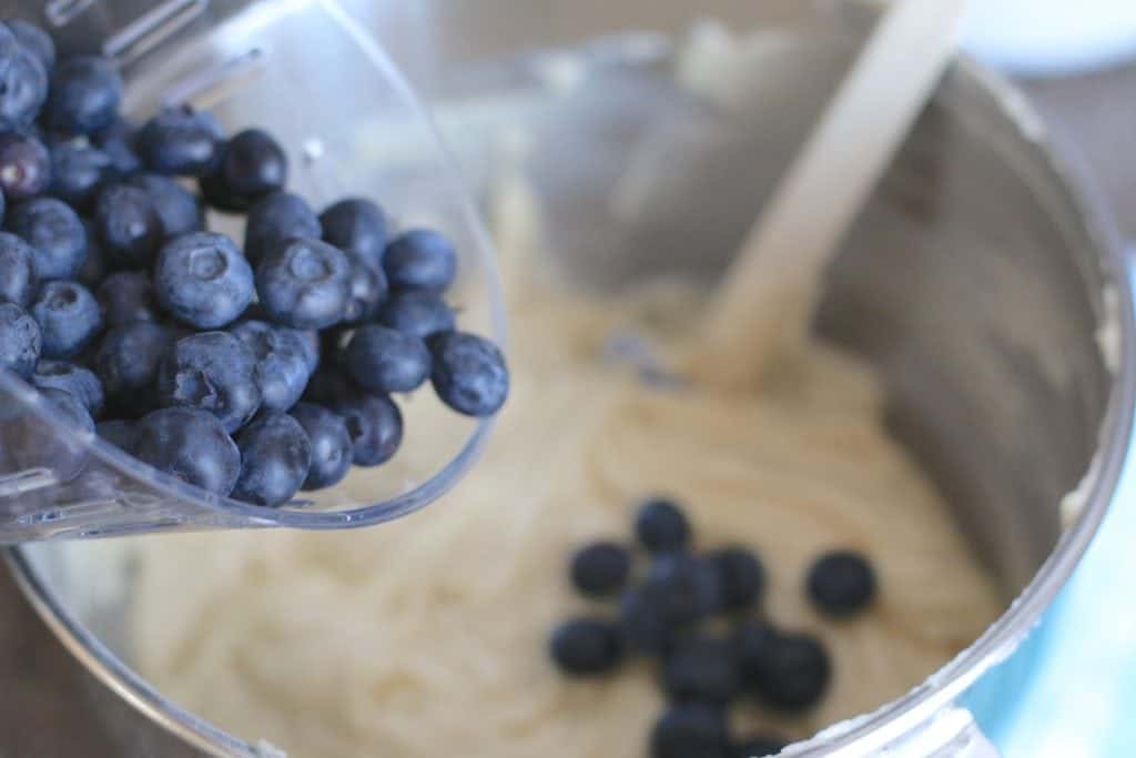 adding fresh blueberries into homemade cake batter