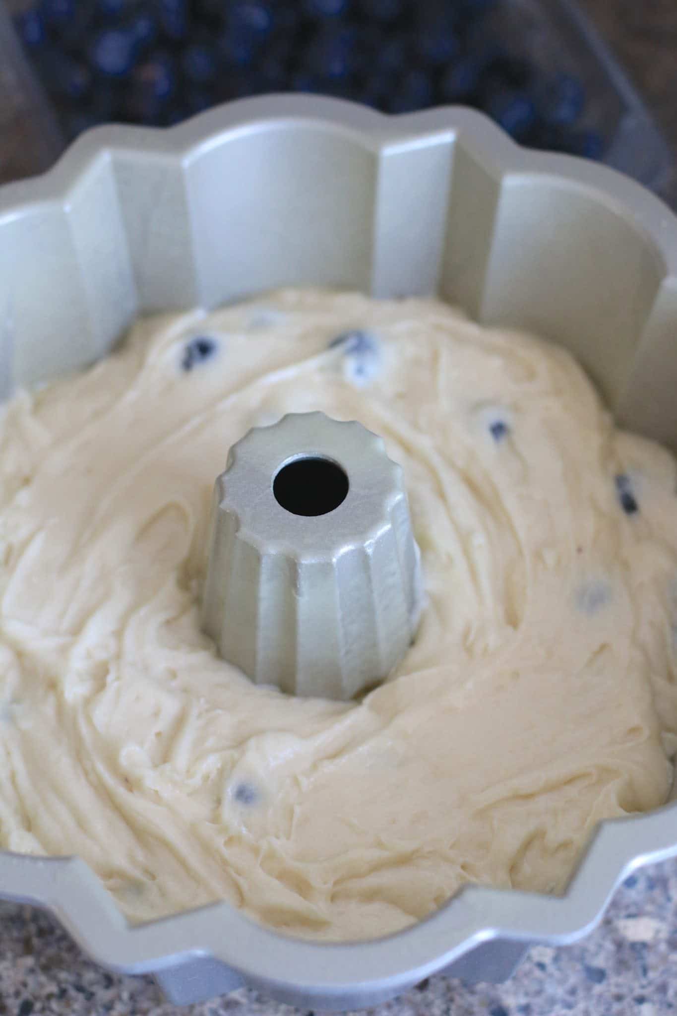 blueberry cake batter added to bundt pan.