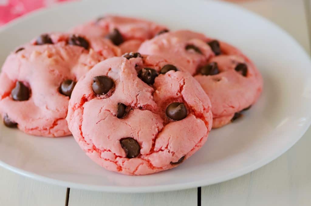strawberry chocolate cookies shown on a round white people.