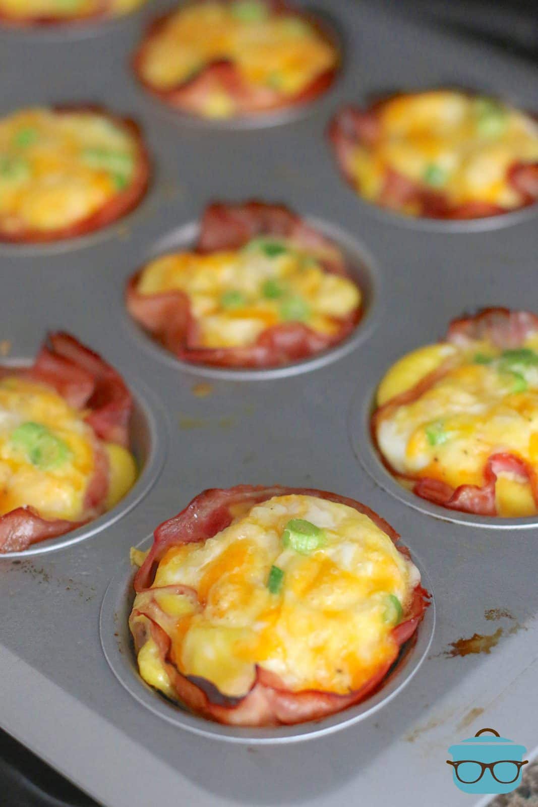 ham and egg cups shown in a muffin tin.