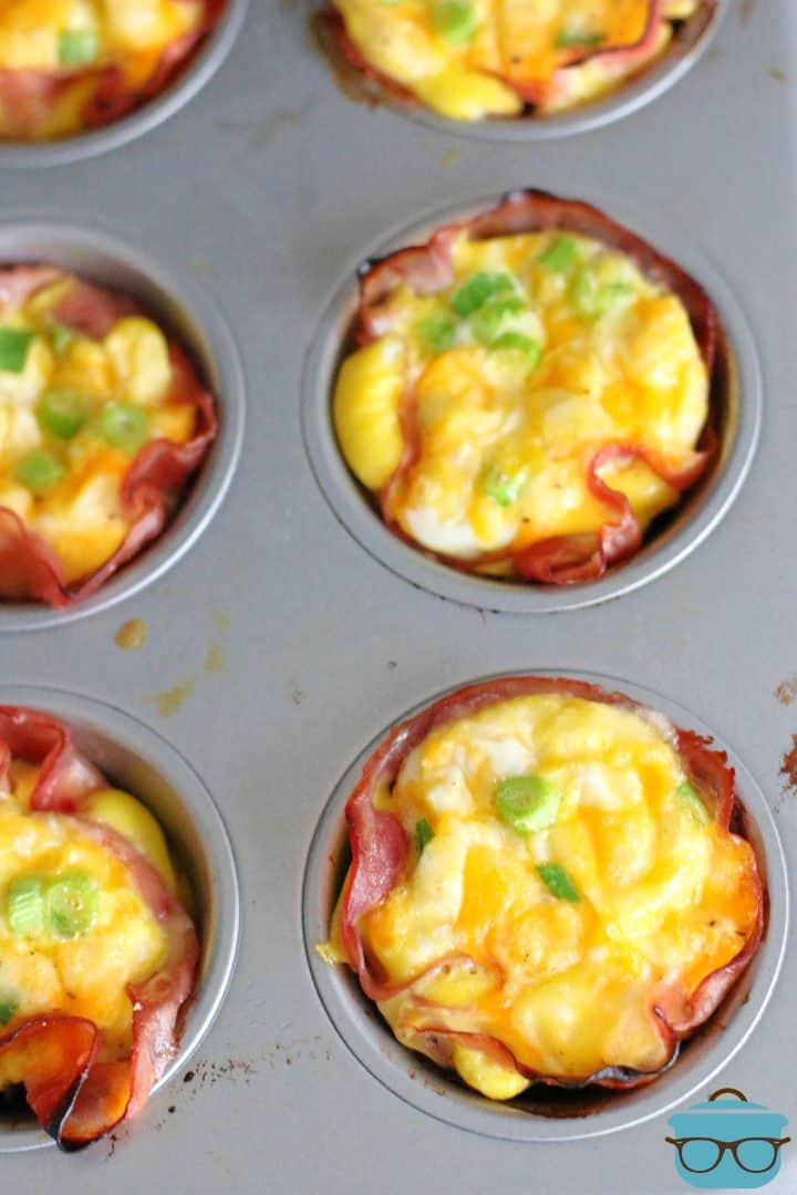 Baked Eggs in Ham Cups shown in a muffin tin.