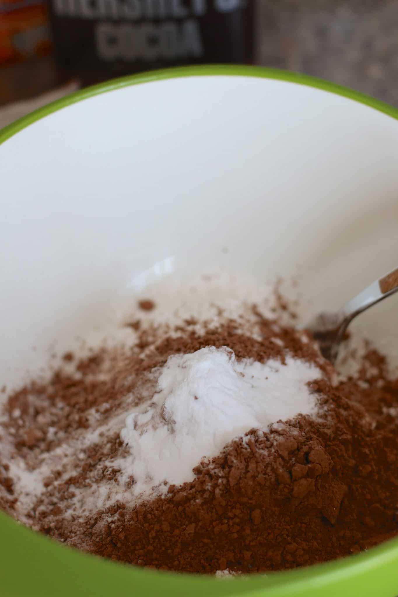 flour, baking soda and cocoa mixed together in a bowl.
