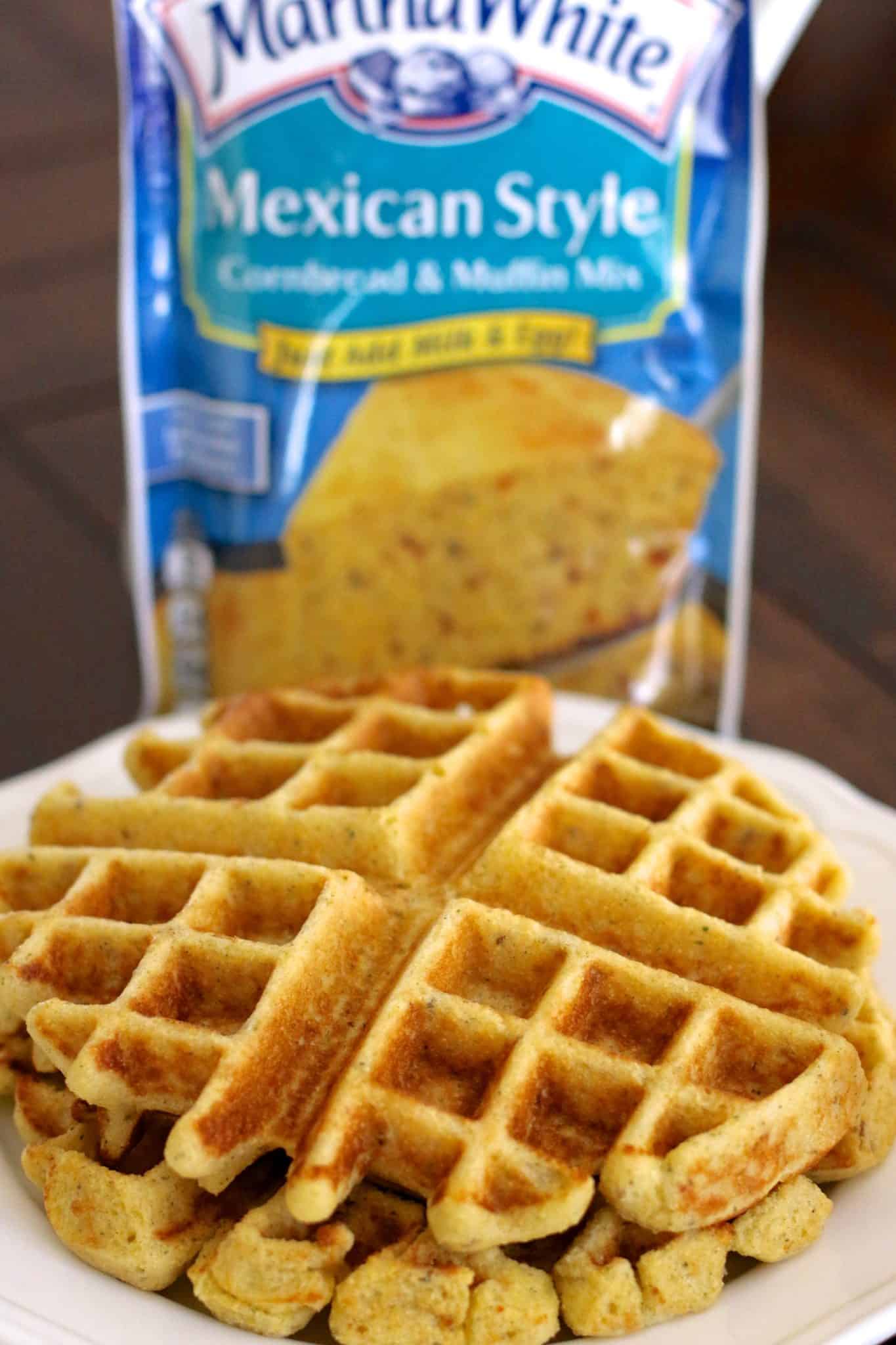 a stack of two cornbread waffles on a white plate. 