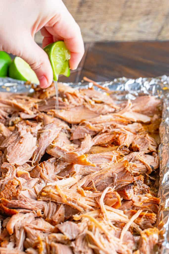 squeezing lime juice on top of shredded pork