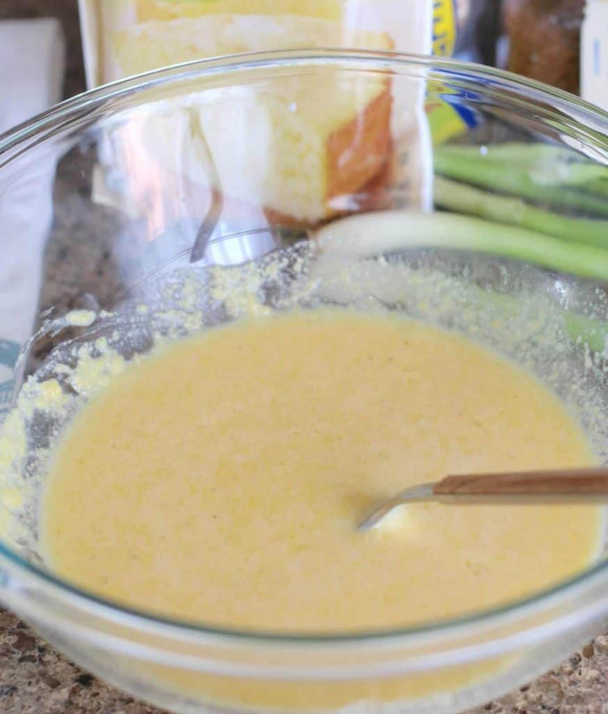 cornbread batter in a bowl with a fork