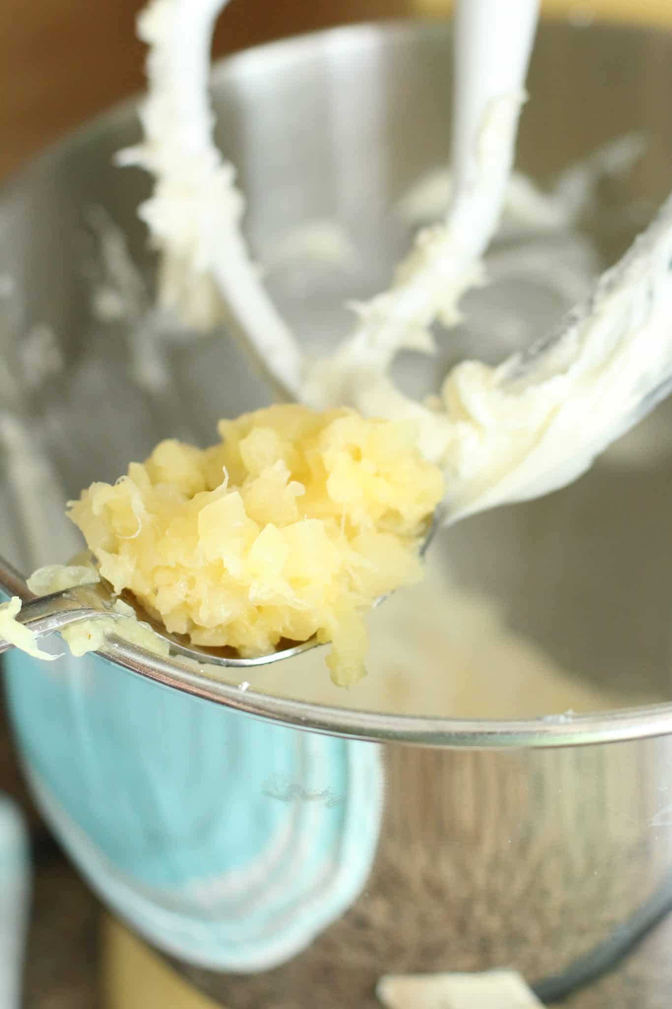 crushed pineapple added to cream cheese mixture in a mixing bowl