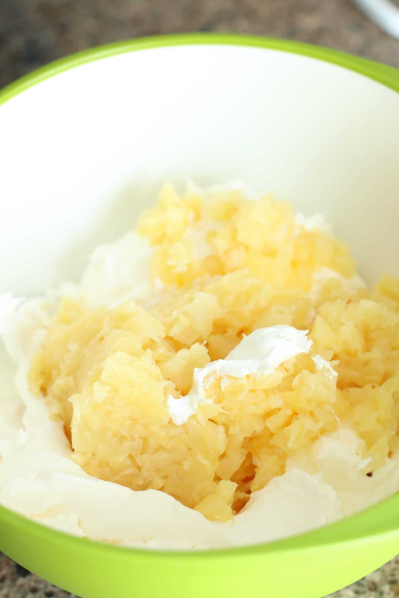 whipped topping and drained crushed pineapple mixed together in a bowl