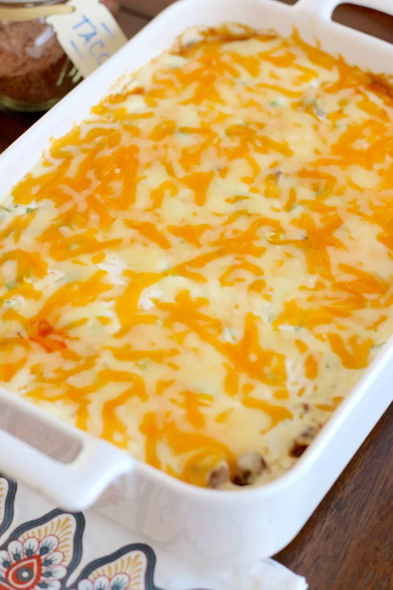 melted cheese on top of baked cornbread taco bake casserole.