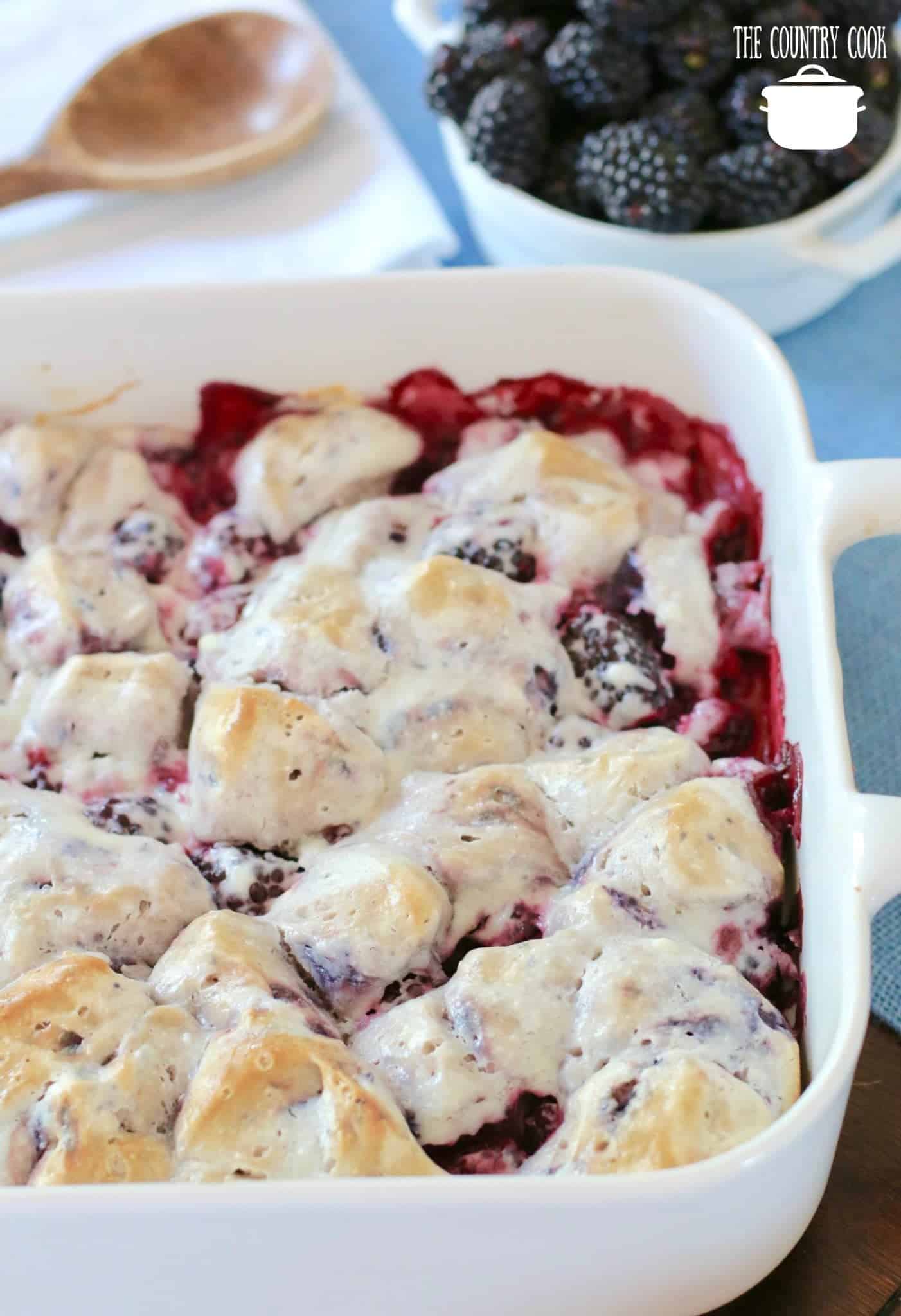 Easy Blackberry Bubble Up recipe with fresh blackberries shown in a white baking dish.
