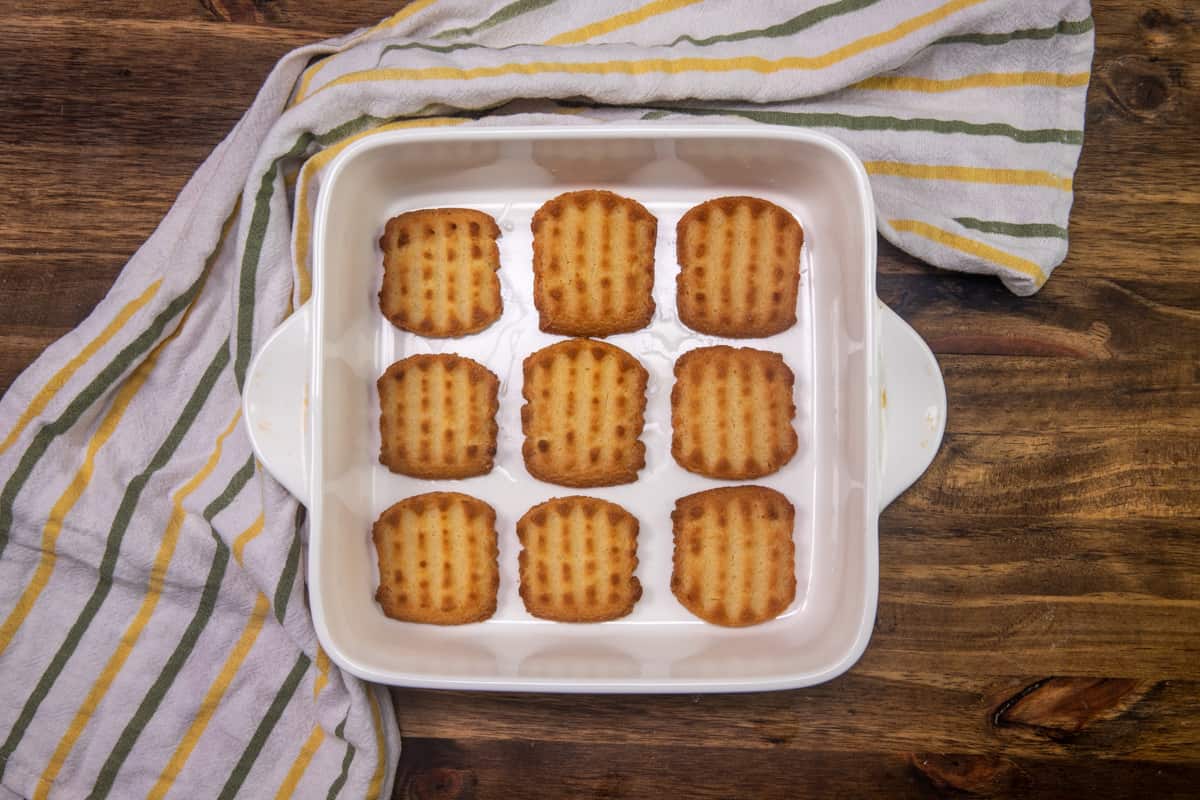 lemon-dipped shortbread cookies layered into the bottom of a white square baking dish.