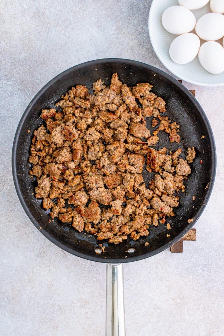 cooked and crumbled and browned ground sausage in a skillet.