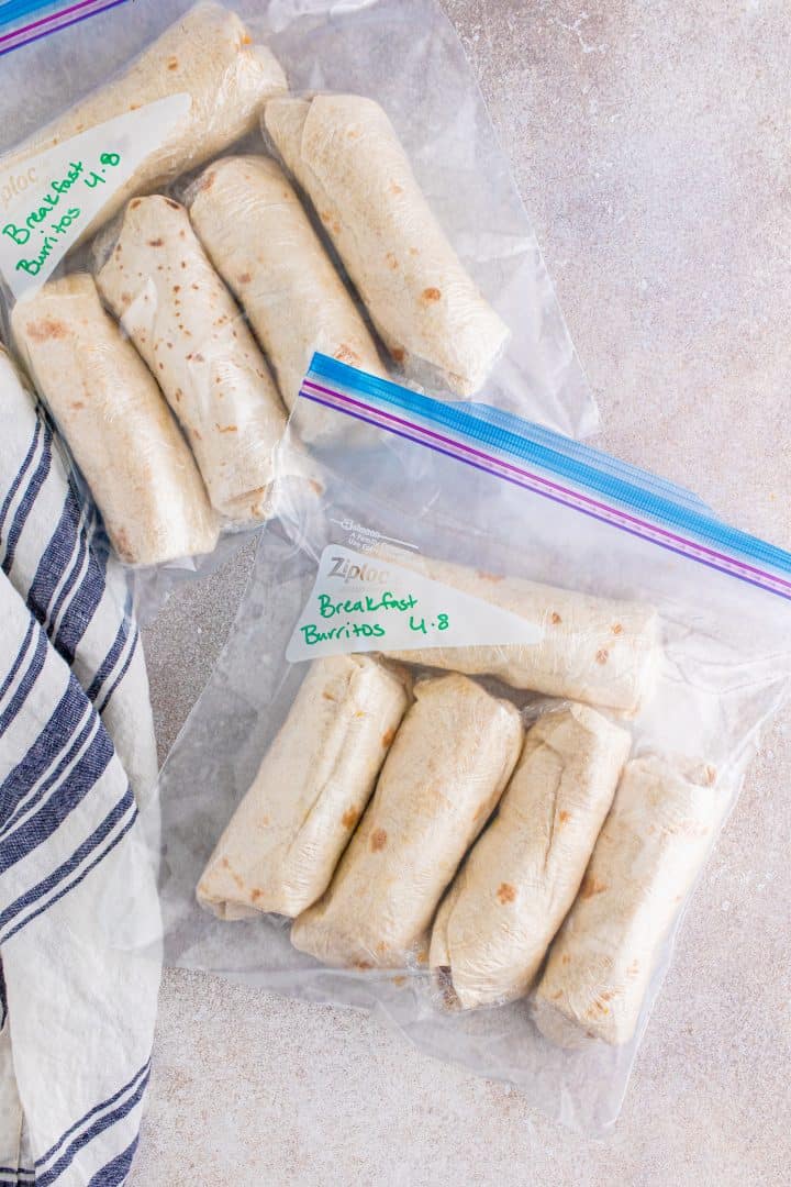 wrapped breakfast burritos shown in freezer safe bags. 