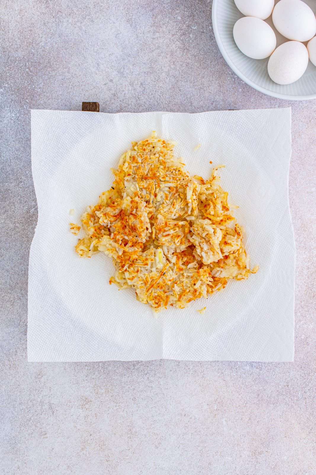 cooked shredded hash browns on a paper towel.