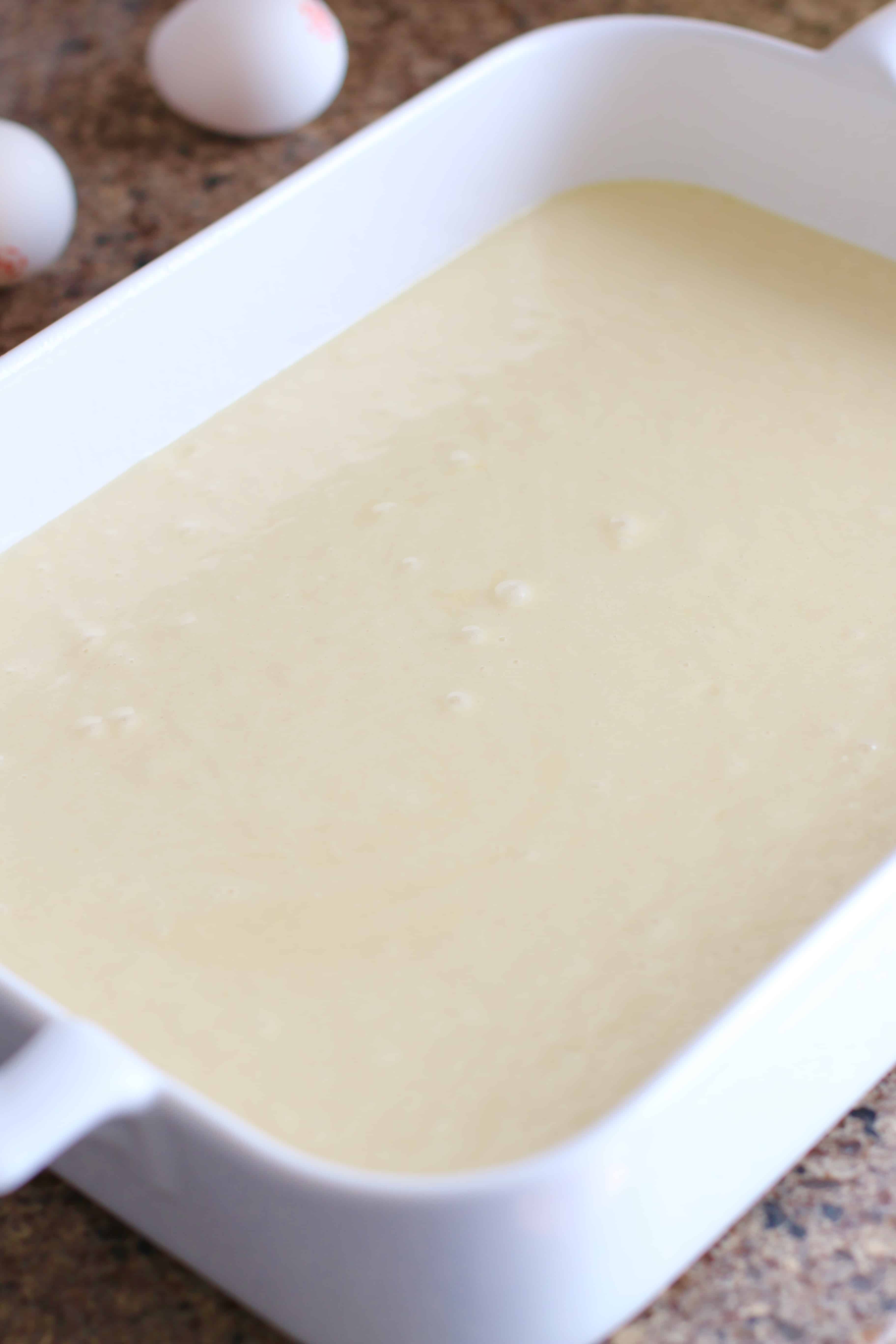 vanilla cake batter in white baking dish.