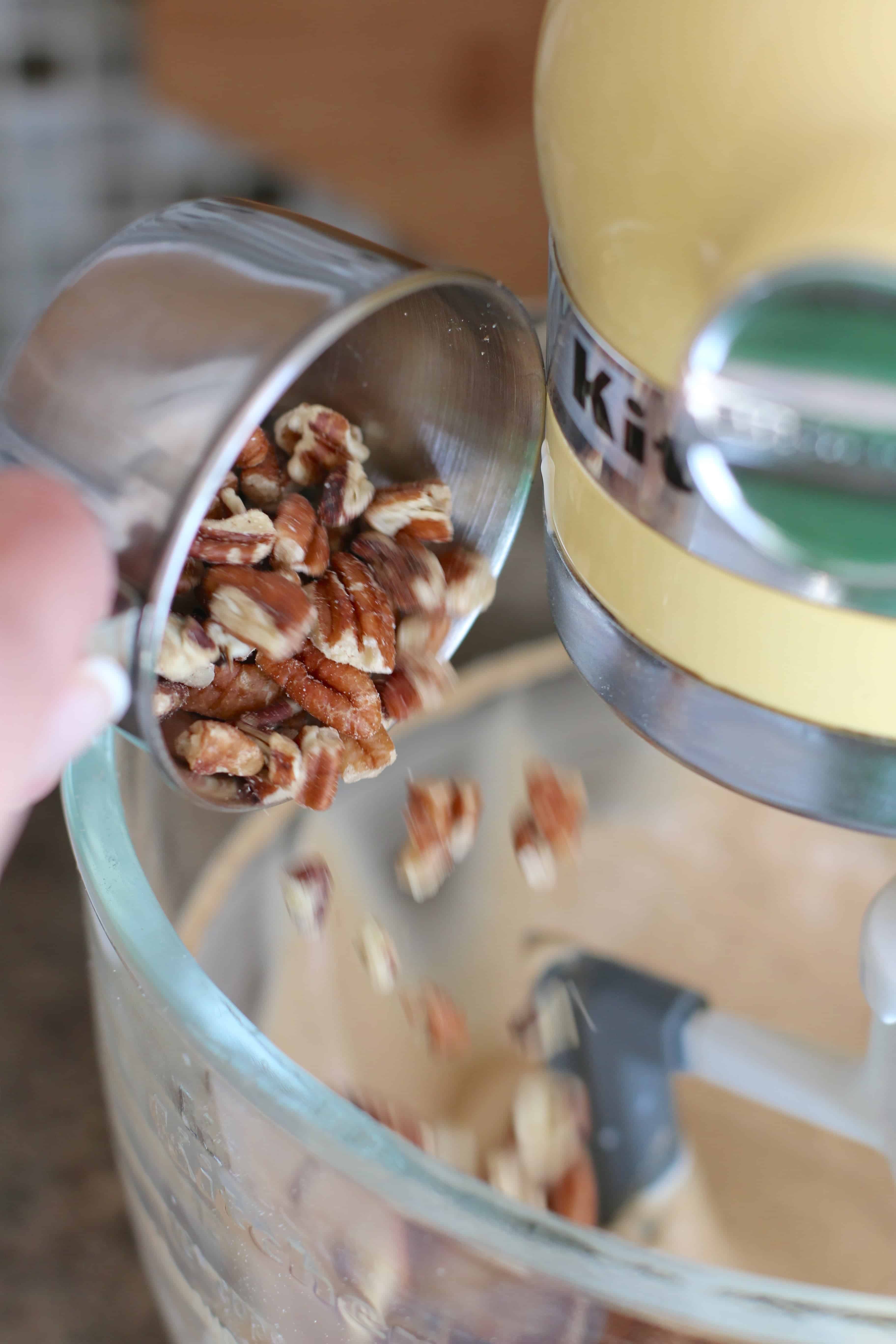 pecans added to muffin mix batter in a stand electric mixer.